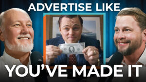 Three men smile as the center man holds a dollar bill; text says "Advertise Like You've Made It"—smart financial planning begins with investing your spending budget.