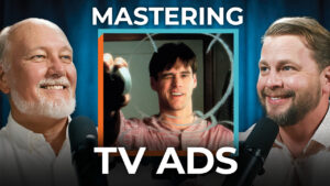 Two men with microphones sit by a smiling man’s image. "Mastering TV Ads" appears above and below, inviting business owners to learn.