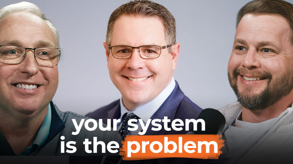 Three smiling men in glasses and suits appear with bold text: "your system is the problem," calling for better corporate training.
