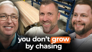 Three smiling men stand before wooden boards that read, "you don't grow by chasing." Billy Cline urges us to play the long game.