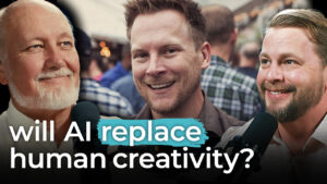 Three men smile and hold microphones as text asks, "Will AI replace human creativity or art?" displayed over the image.