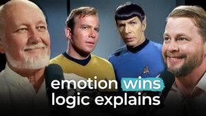 Four men stand together; two wear Star Trek uniforms. Text reads: "Emotion wins, logic explains.