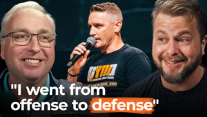 Three men smile as one speaks into a microphone; text says, "I move from offense to defense—selling my business brings new opportunities.